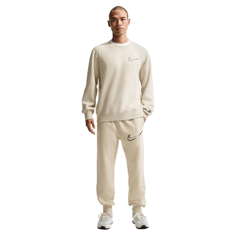 Front view of the Nike Club Track Sweatpants in Light Khaki and Obsidian colourway, men model
