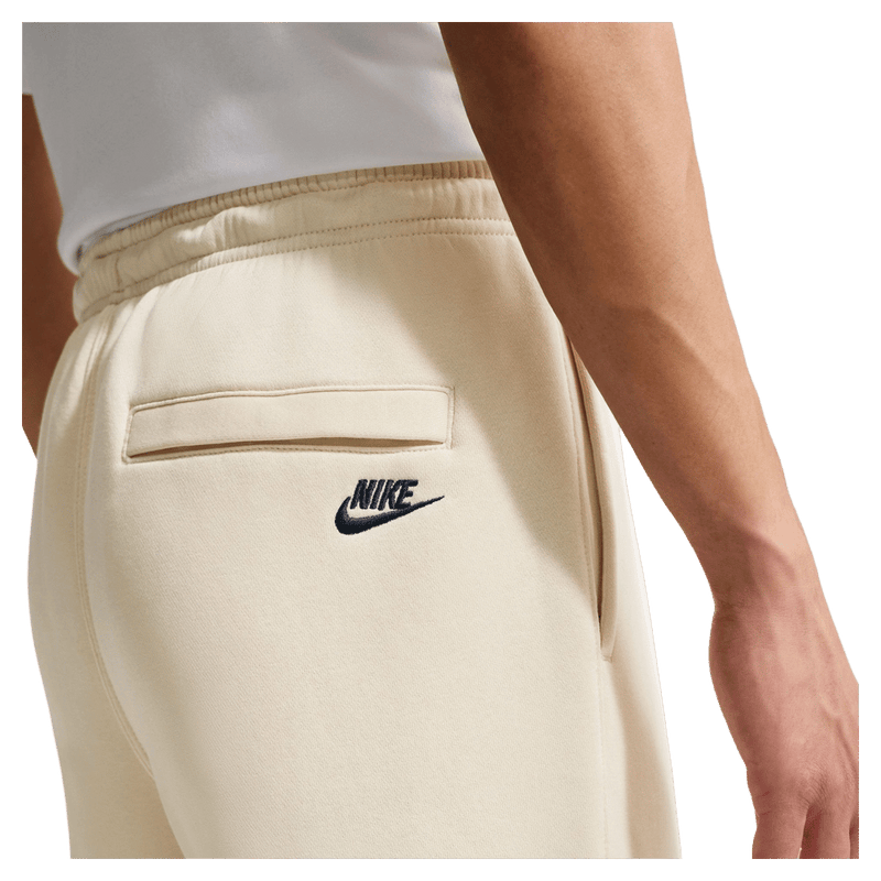 Detail view of the Nike Club Track Sweatpants in Light Khaki and Obsidian colourway, men model