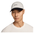 Front view of the Nike Club Cap in Sail and Black colourway, unisex model