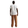 Back view of the Nike Club Pants in Ale Brown colourway, unisex model
