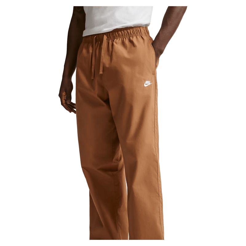 Main view of the Nike Club Pants in Ale Brown colourway, unisex model