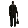 Back view of the Nike Club Pants in Black colourway, unisex model