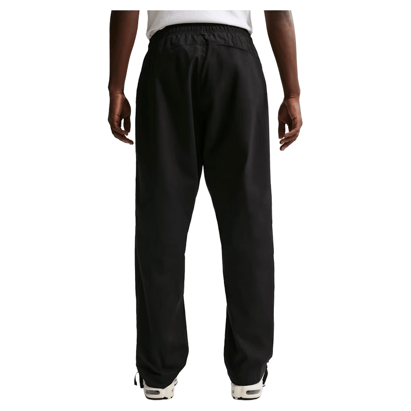 Back view of the Nike Club Pants in Black colourway, unisex model