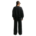 Back view of the Nike Phoenix Fleece Sweatpants in Black colourway, women model
