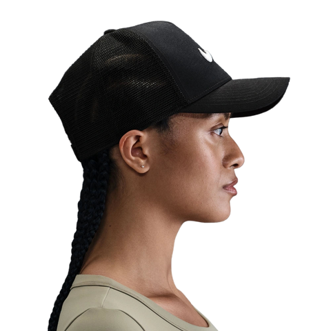 Side image of the Nike Rise Cap on a women in Black