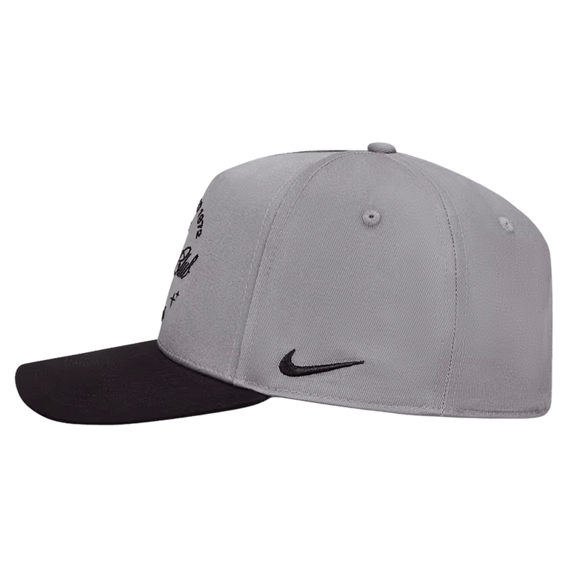 Side view of the Nike Rise Cap in Smoke Grey colourway, unisex model