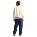 Back view of the Nike  Sportswear Club Fleece Crew Neck in Soft Pearl colourway, kids model