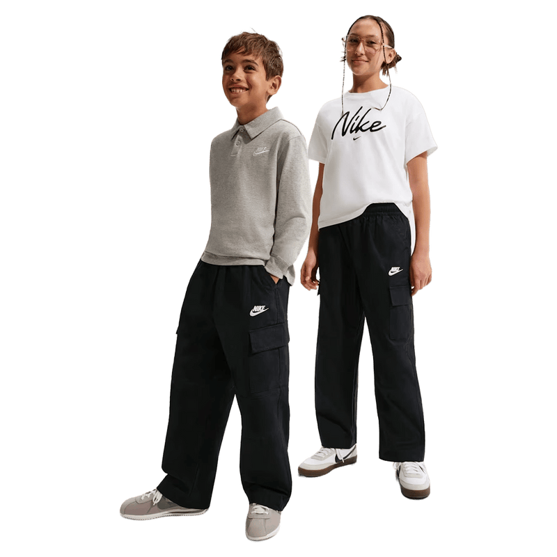 Kids view of the Nike Sportswear Club Woven Cargo Pants in Black and White colourway, kids model