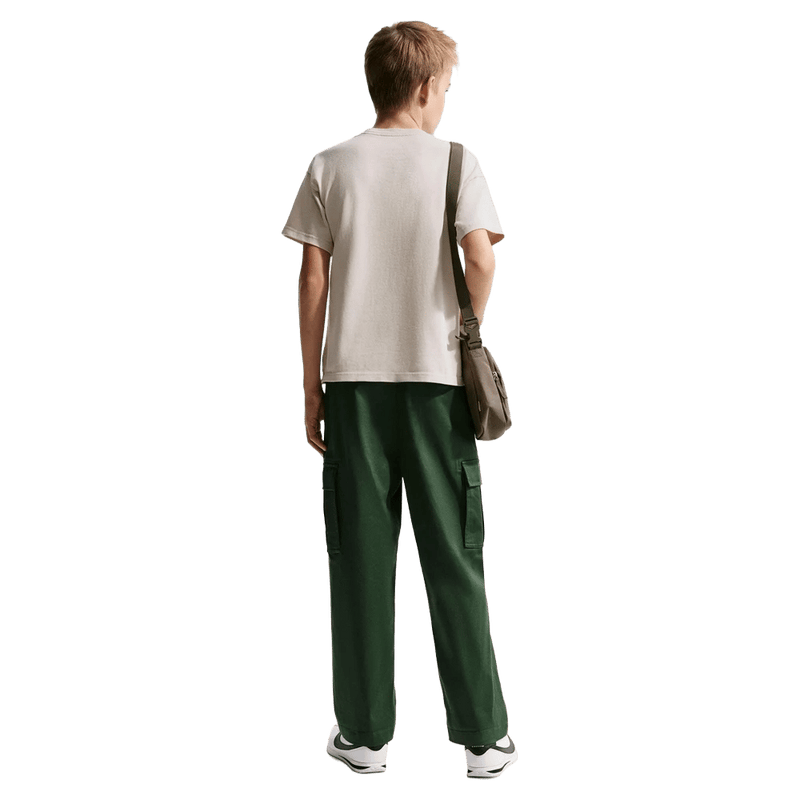 Back view of the Nike Sportswear Tee in Light Orewood Brown colourway, kids model