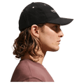 Side view of the Nike Unstructured Cap in College Grey colourway, unisex model