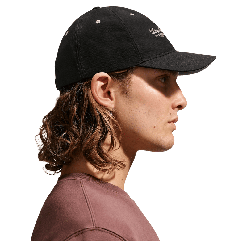 Side view of the Nike Unstructured Cap in College Grey colourway, unisex model