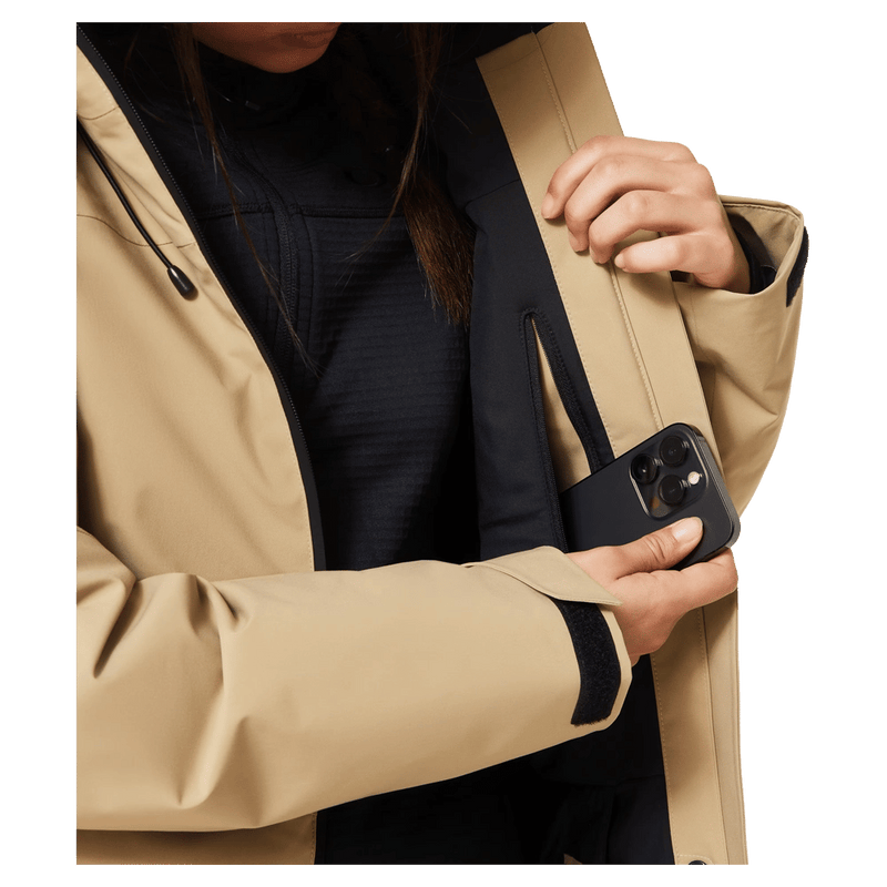 Media pocket view of the Oakley Canopy Insulated Jacket in Pebble colourway, women model