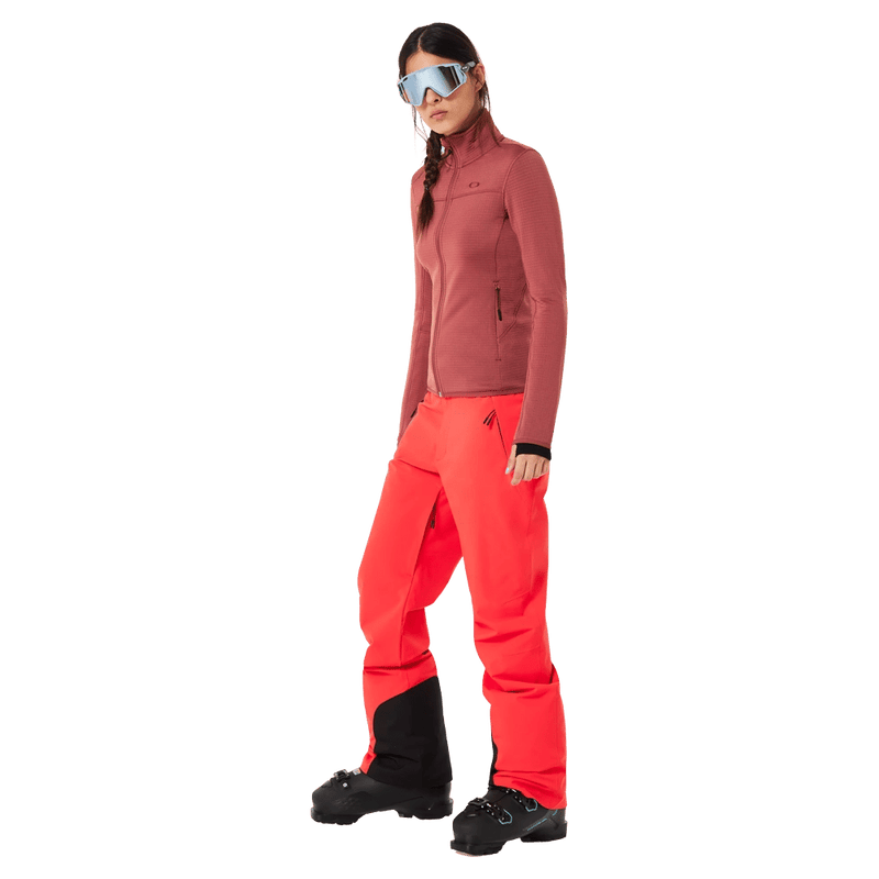 Front view of the Oakley Canopy Insulated Ski Pants in HIBISCUS RED colourway, women model