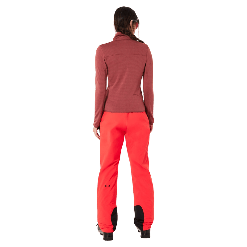 Back view of the Oakley Canopy Insulated Ski Pants in HIBISCUS RED colourway, women model