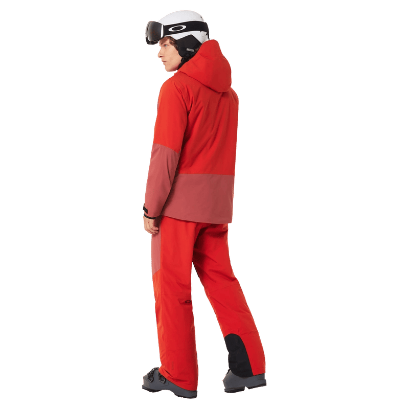 Full-body view of the Oakley Canopy Pro Insulated Ski Pants in FLAME RED and ROSEWOOD colourway, men's model