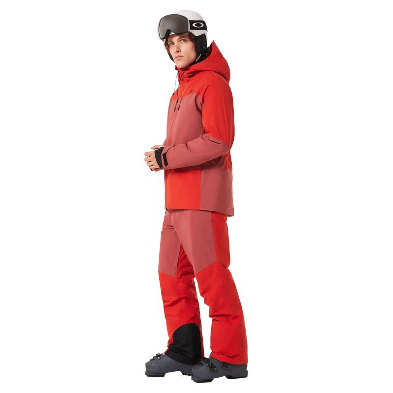 Full-body view of the Oakley Canopy Pro Insulated Ski Pants in FLAME RED and ROSEWOOD colourway, men's model
