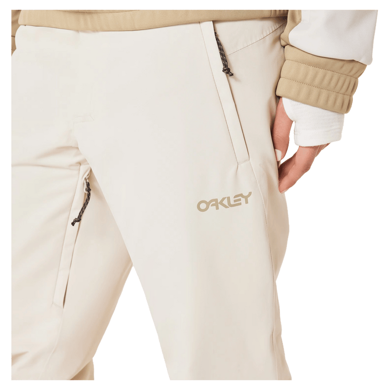 Detail view of the Oakley Jasmine Insulated Ski Pants in Mist and Pebble colourway, women's model
