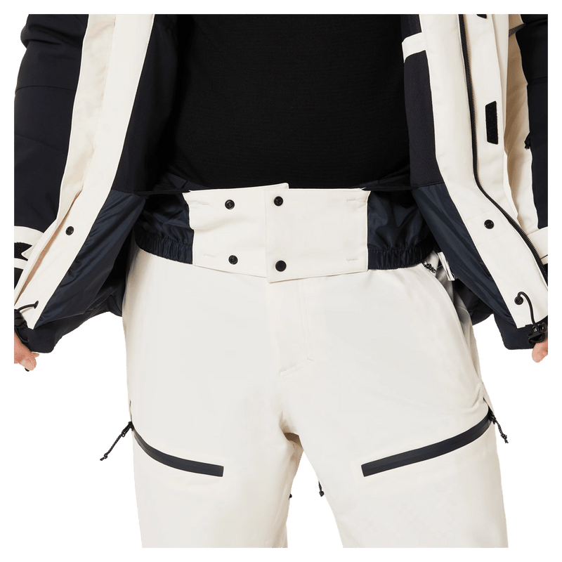 Powder skirt view of the Oakley Tnp Tbt Insulated Ski Jacket in Mist colourway, unisex's model