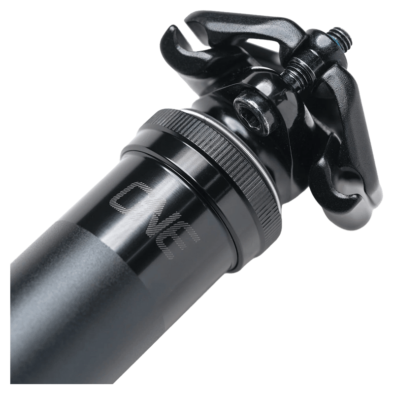 Detail view of the One Up V3 Dropper Post in Black colourway, unisex model