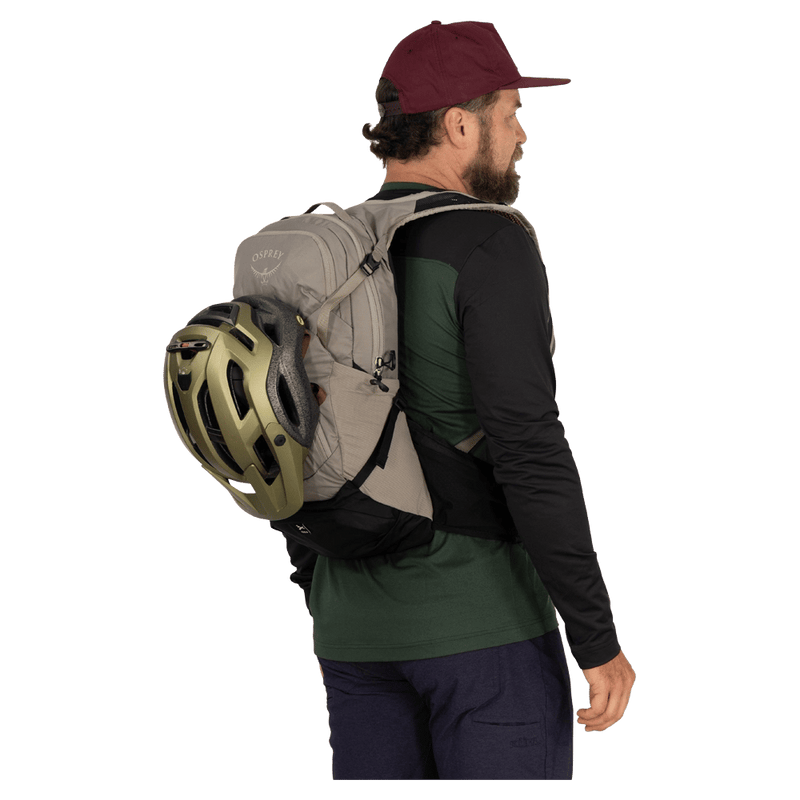 Carried view of the Osprey Raptor 14L Hydration Bag in Grey colourway, men model