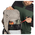 Pocket view of the Osprey Raptor 14L Hydration Bag in Grey colourway, men model