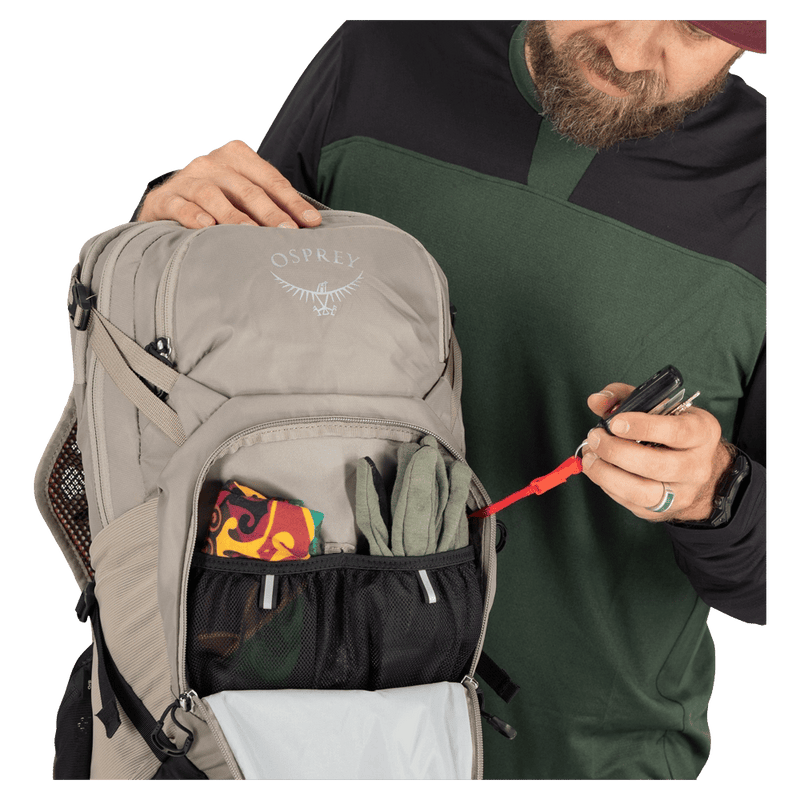 Pocket view of the Osprey Raptor 14L Hydration Bag in Grey colourway, men model