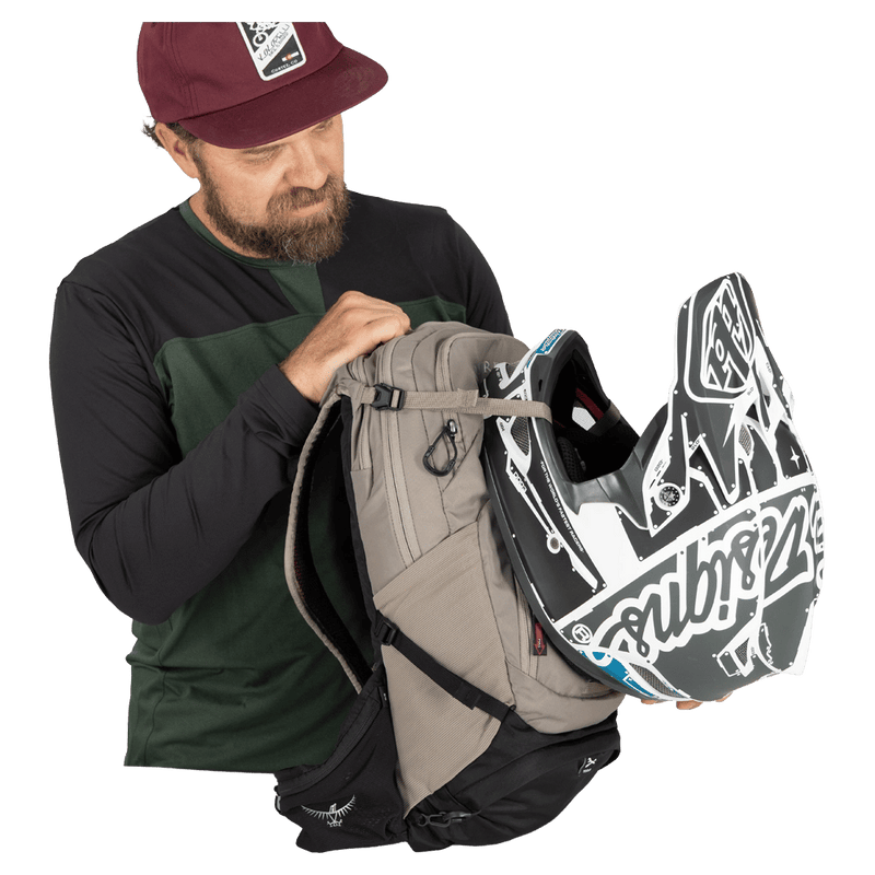 MTB Helmet carrier  view of the Osprey Raptor 14L Hydration Bag in Grey colourway, men model