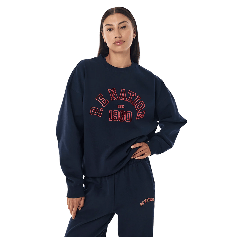 Front view of the P.E Nation Established Jumper in Dark Navy colourway, women model