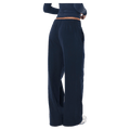 Back view of the P.E Nation Legacy Trackpant in Dark Navy colourway, women model