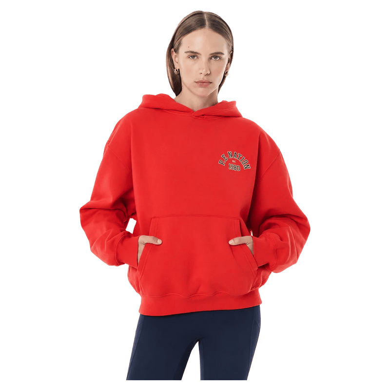 Front view of the P.E Nation Established Hoodie in College Red colourway, women model