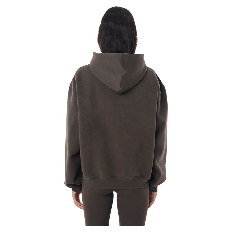 Back view of the P.E Nation Core Hoodie in Dark Olive colourway, women model