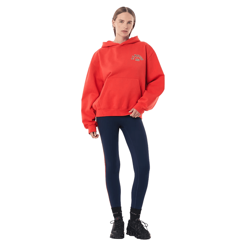 Full-body view of the P.E Nation Established Hoodie in College Red colourway, women model