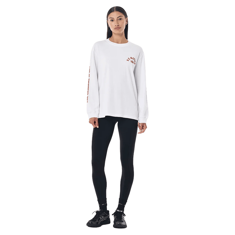 Full-body view of the P.E Nation Established Long Sleeve Tee in Optic White colourway, women model