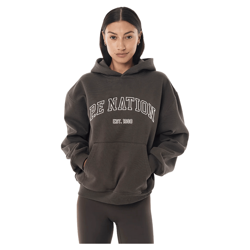 Front view of the P.E Nation Core Hoodie in Dark Olive colourway, women model