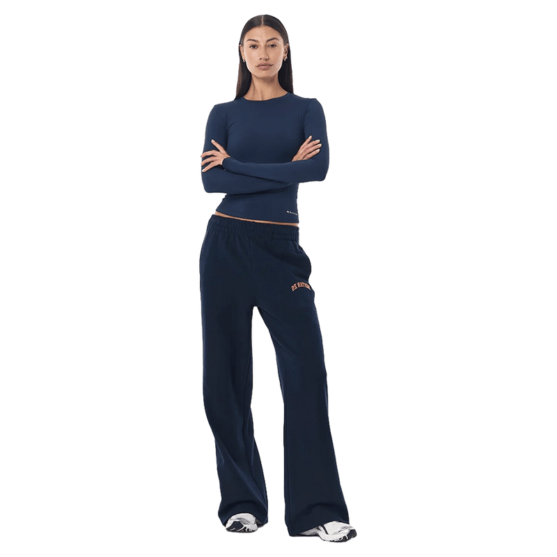 Full-body view of the P.E Nation Legacy Trackpant in Dark Navy colourway, women model