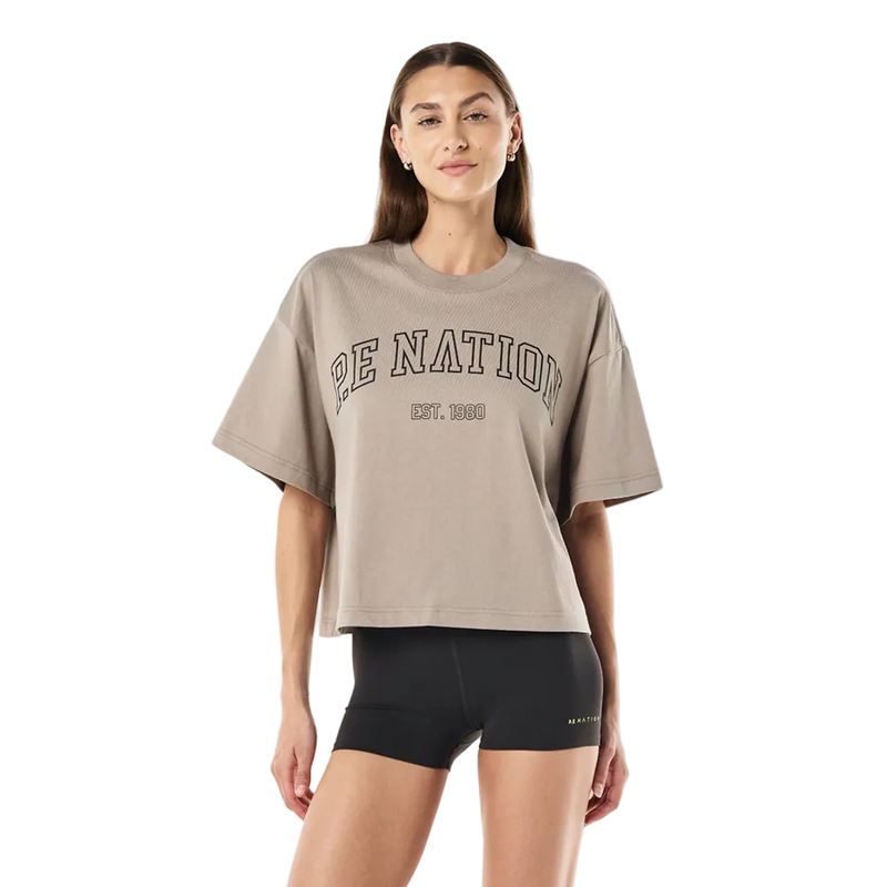 Front view of the P.E Nation Area Tee in Oatmeal colourway, women's model