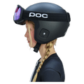 Side view of a child wearing a matte black POC Skull Dura Jr helmet with matching goggles and purple lenses.