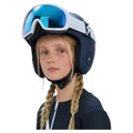 Young girl wearing a navy blue Poc Skull Dura Jr kids' ski helmet and white goggles with blue lenses.