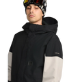 Detail image of the Primry Snowboard Jacket in Black. Featuring toggle cinched hood, covered placket, and chest pocket with zip closure.