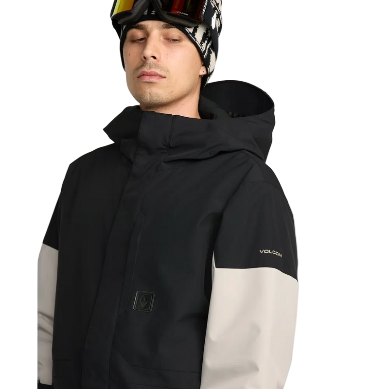 Detail image of the Primry Snowboard Jacket in Black. Featuring toggle cinched hood, covered placket, and chest pocket with zip closure.