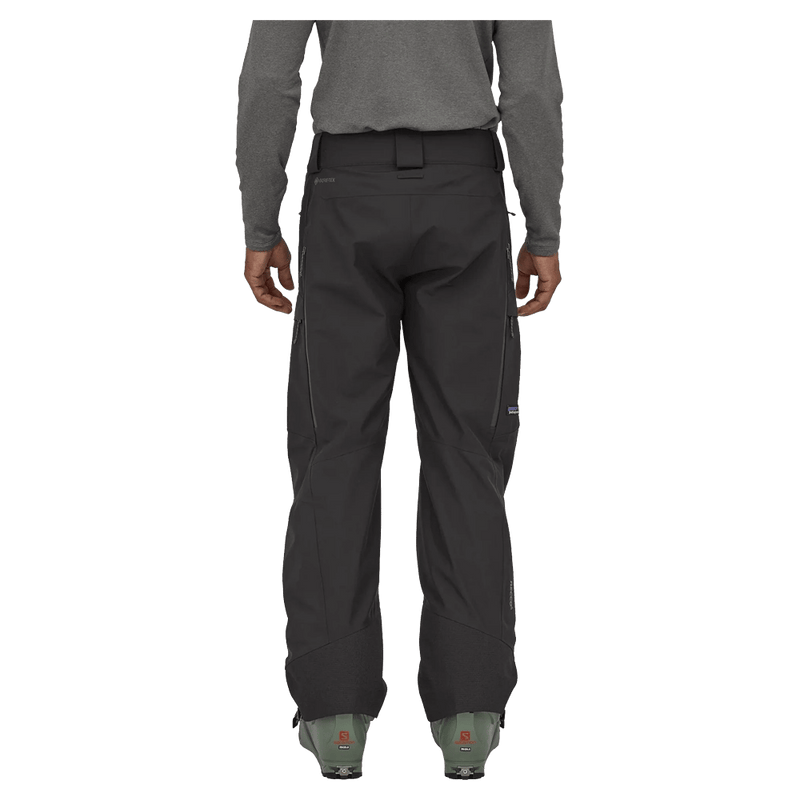 Rear view of dark grey Patagonia Storm Shift Ski Pants with zippered pockets, belt loops, and a straight leg fit.