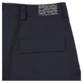 Close-up of navy Resolve Sprinter baggy cargo ski pants showing the waistband, logo patch, and flap back pocket.