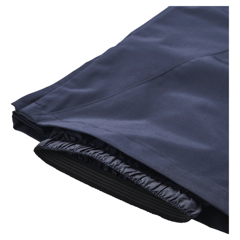 Close-up of navy Resolve Sprinter ski pants showing the inner elastic snow gaiter and outer shell fabric.