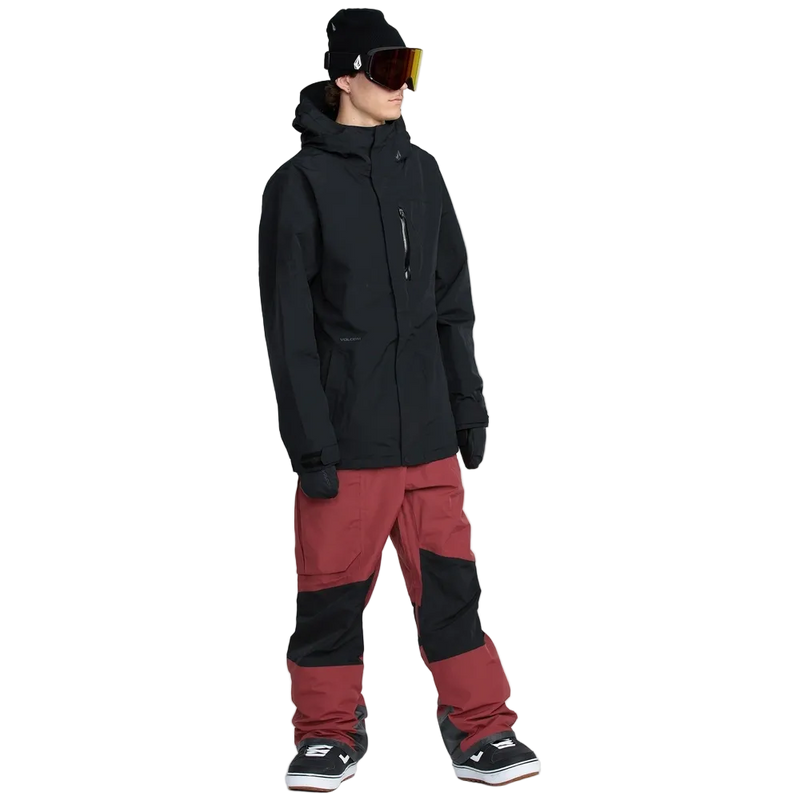 Front, on-body image of the Rain Gore-Tex Bib Snowboard Pants from Volcom in Burnt Red paired with jacket.