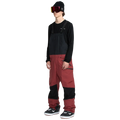 Side, on-body image of the Rain Gore-Tex Bib Snowboard Pants from Volcom in Burnt Red