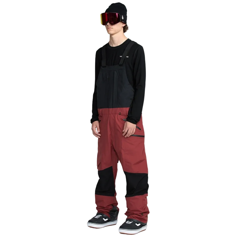 Side, on-body image of the Rain Gore-Tex Bib Snowboard Pants from Volcom in Burnt Red