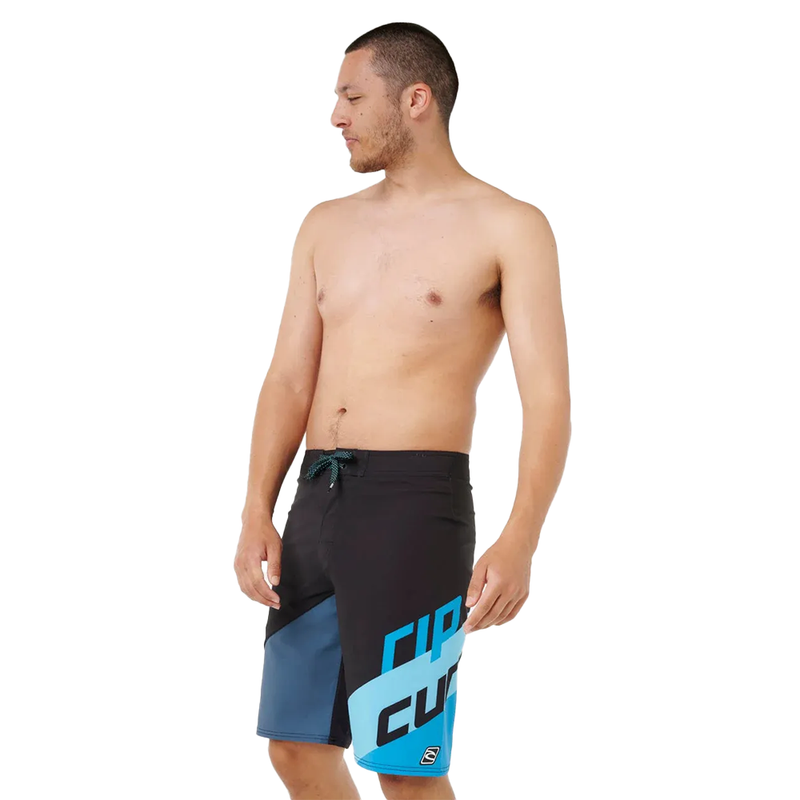 Lifestyle image of the Mirage Little Mali Boardshorts in Blue Black