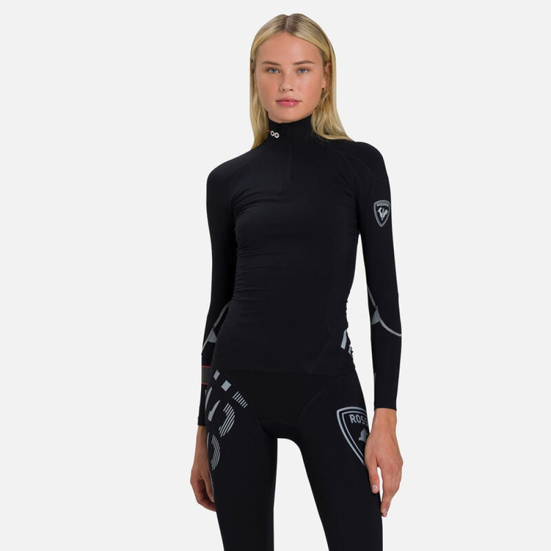 Tight-fit black Rossignol Infini Compression Race Top with high neck and grey graphic details on the sleeves. Shown on model