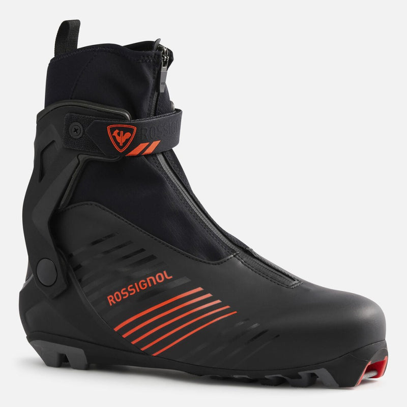 Black Rossignol X-9 Skate cross-country ski boot with orange accents, zippered lace cover, and supportive ankle wrap strap.