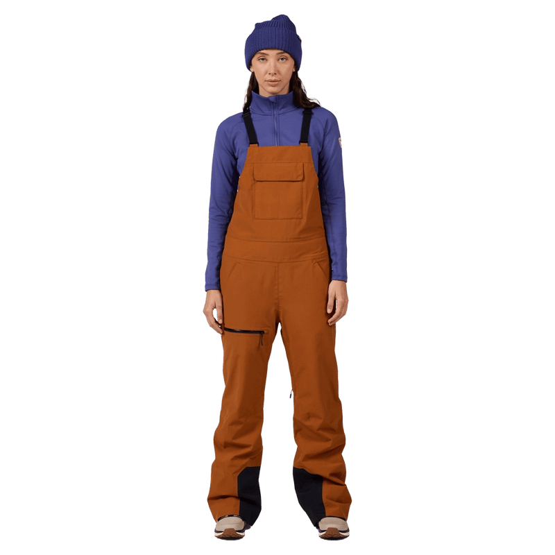 Front view of the Rossignol Outerlimits Insulated Bib in DEEP CARAMEL colourway, women model